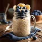 Soy free overnight oats with bananas and blueberries in a mason jar